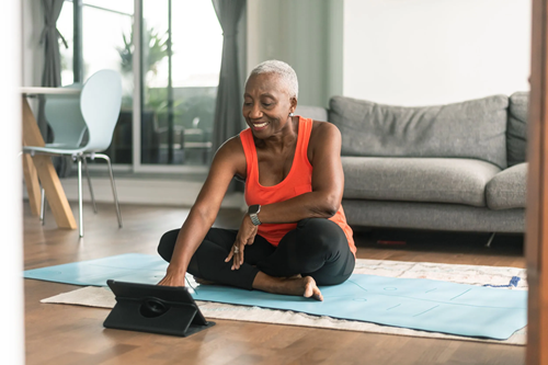 Senior streaming yoga lessons on the internet